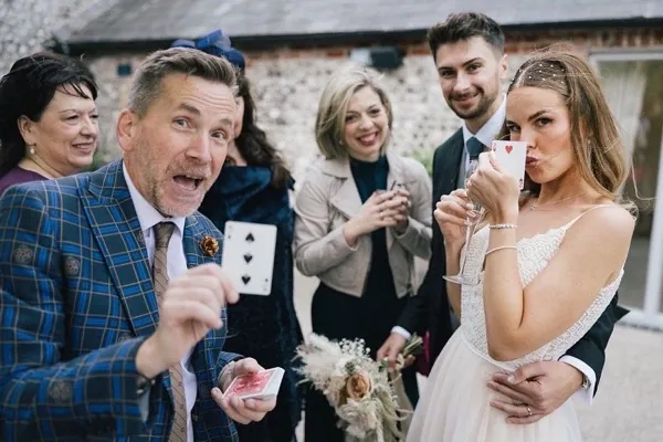 Martin Sanderson performing close-up magic for guests at a wedding reception