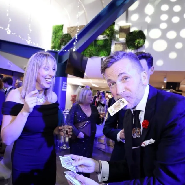 Martin Sanderson performing card magic at a birthday celebration